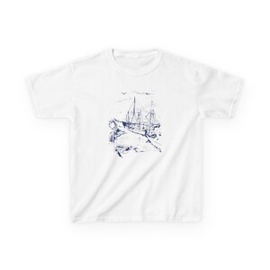 A white t-shirt with a blue ink drawing of a ship docked at a pier. Sailboats Baby Tee, Seashell Baby Tee, Nautical Baby Tee, Nautical T-Shirt, Ocean Theme Crop Tee, Beach Day Crop Top, Summer Baby Tee