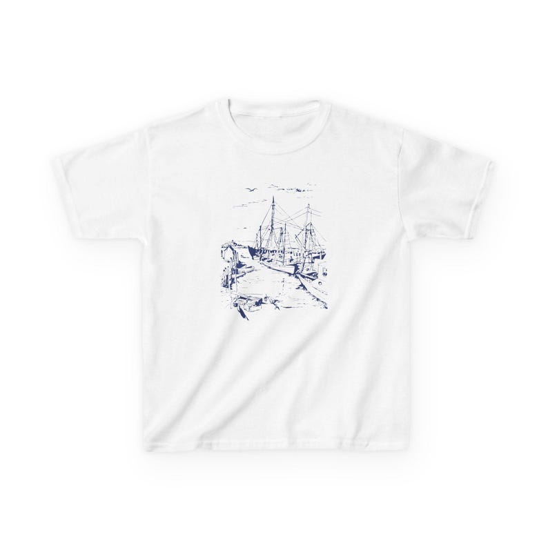 A white t-shirt with a blue ink drawing of a ship docked at a pier. Sailboats Baby Tee, Seashell Baby Tee, Nautical Baby Tee, Nautical T-Shirt, Ocean Theme Crop Tee, Beach Day Crop Top, Summer Baby Tee