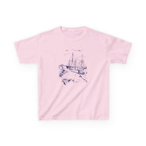 A pink t-shirt with a blue and white illustration of a ship docked at a pier. Sailboats Baby Tee, Seashell Baby Tee, Nautical Baby Tee, Nautical T-Shirt, Ocean Theme Crop Tee, Beach Day Crop Top, Summer Baby Tee