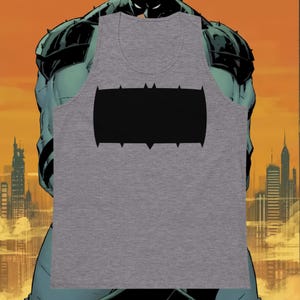 May include: A gray tank top featuring a black bat symbol. The sleeveless shirt has a scoop neck and is made of a soft material. The design is a graphic representation of a bat symbol.