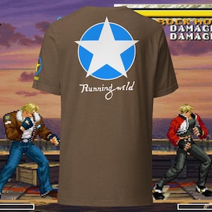 May include: Brown t-shirt featuring a white star inside a blue circle on the back, with the words "Running wild" in script. A small yellow star is on the left sleeve. The shirt is part of a video game-themed collection.