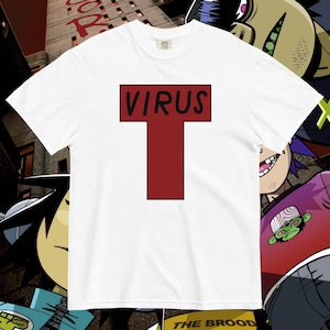May include: White t-shirt with a bold red "T" design, the word "VIRUS" in black lettering at the top. This graphic tee is a comfortable fit. The design is part of a collection of graphic t-shirts.