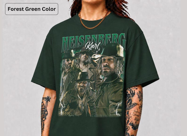 May include: Dark forest green t-shirt with a graphic of a man and the text "HEISENBERG Karl". The design has a vintage aesthetic, with multiple images of the same man. The shirt is a deep green colour.