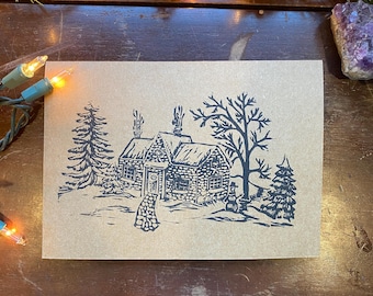Tarjeta navideña impresa a mano con diseño de cabaña nevada / Impresión en linóleo
