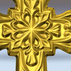 May include: A gold-coloured cross featuring intricate floral and scrollwork patterns. The cross has a polished, reflective surface and a three-dimensional design. The symmetrical design includes a central floral element and curved edges.