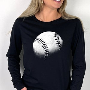 May include: A black long-sleeved t-shirt with a white baseball graphic.
