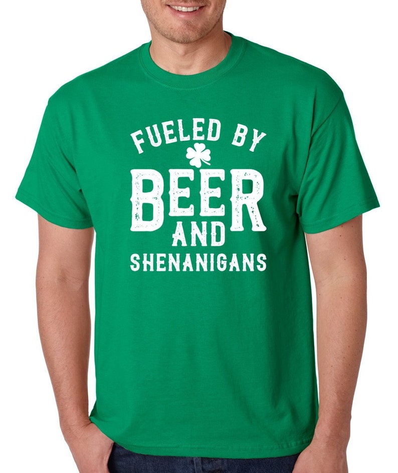 May include: Green t-shirt with a white graphic that says "Fueled by Beer and Shenanigans" with a shamrock.
