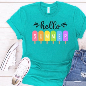 May include: A teal blue t-shirt with the text "hello summer" in black lettering. The text is surrounded by colorful popsicle graphics.