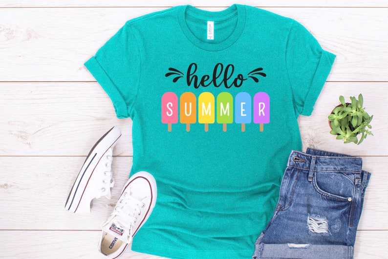 May include: A teal blue t-shirt with the text "hello summer" in black lettering. The text is surrounded by colorful popsicle graphics.