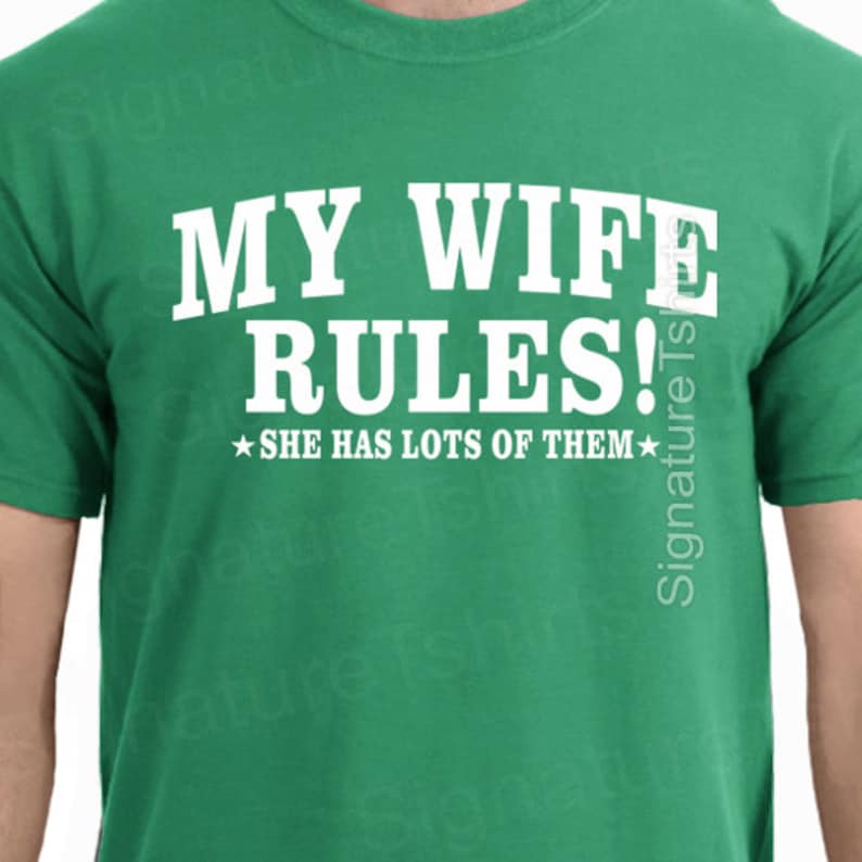 May include: Green t-shirt with white text that reads "MY WIFE RULES!  ★SHE HAS LOTS OF THEM★"