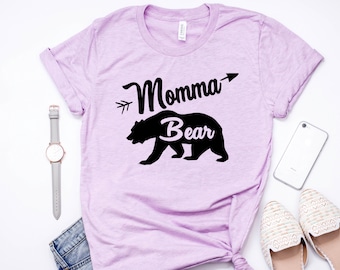 May include: A light purple t-shirt with a black bear silhouette and the text "Momma Bear" with an arrow pointing to the right.