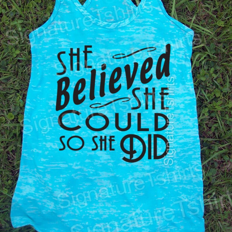 May include: A turquoise blue tank top with a black graphic that reads "She Believed She Could So She Did".