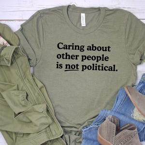Caring about people is not political, Protest Shirt, Social Worker Shirt, Human Rights Shirt, Teacher Gift, Political Activism Shirts Heather Military/bl