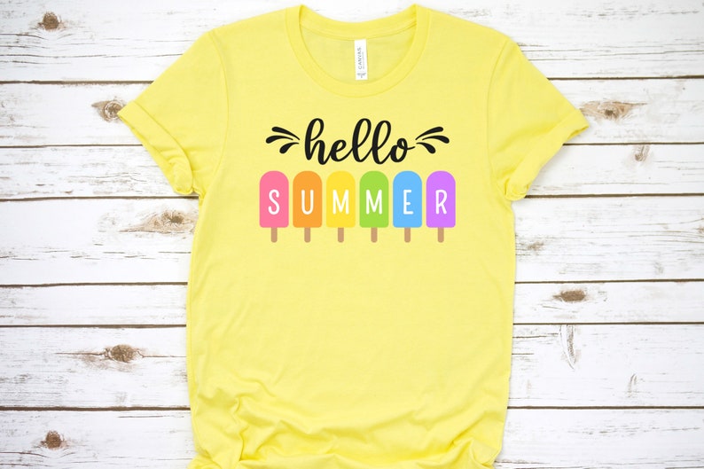 May include: Yellow t-shirt with the text "hello summer" in black lettering. The text is surrounded by rainbow popsicle graphics.