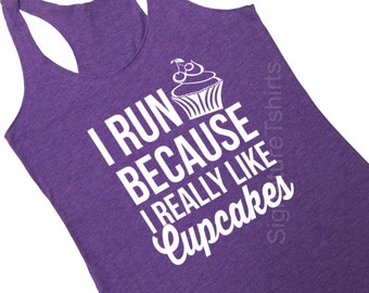 May include: Purple tank top with a white graphic that says "I run because I really like cupcakes" and a cupcake illustration.