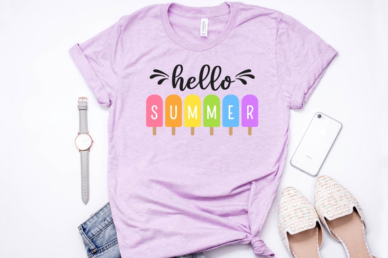 May include: A light purple t-shirt with the text "hello summer" and a row of colorful popsicles.
