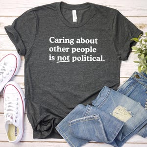 Caring about people is not political, Protest Shirt, Social Worker Shirt, Human Rights Shirt, Teacher Gift, Political Activism Shirts Dark Heather/white