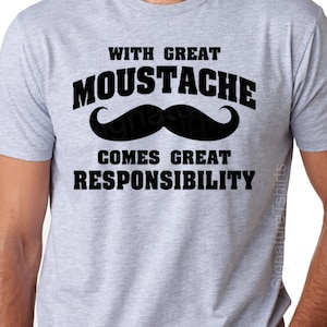 May include: A gray t-shirt with black text that reads "With great moustache comes great responsibility". A black mustache graphic is above the text.