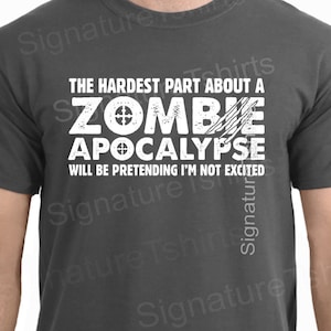 May include: A dark grey t-shirt with a white graphic print that reads "The Hardest Part About A Zombie Apocalypse Will Be Pretending I'm Not Excited".