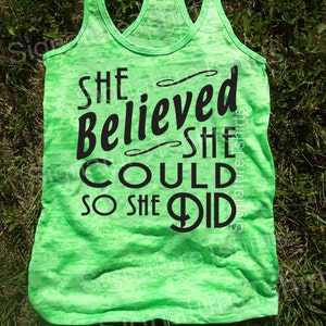 May include: Green tank top with a black graphic that reads "She believed she could so she did".