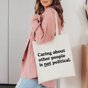 Caring about people is not political, Protest Shirt, Social Worker Shirt, Human Rights Shirt, Teacher Gift, Political Activism Shirts TOTE BAG (NATURAL)