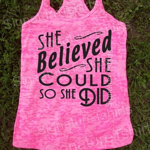 May include: Pink tank top with a black graphic that reads "She believed she could so she did".