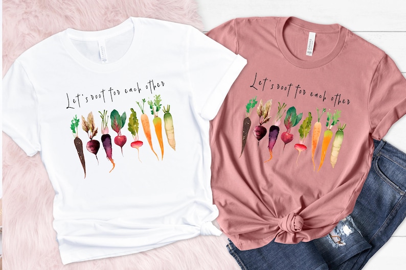 May include: Two t-shirts with the text "Let's root for each other" and a watercolor illustration of various vegetables, including carrots, radishes, and beets.