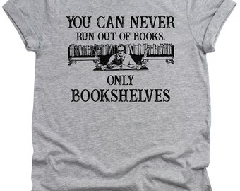 May include: Gray t-shirt with the text "You can never run out of books. Only bookshelves."