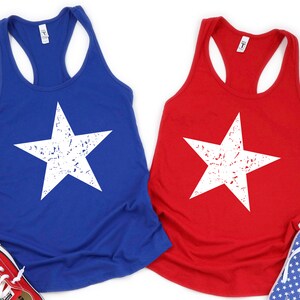 May include: Two tank tops with a white distressed star design. One tank top is blue and the other is red.