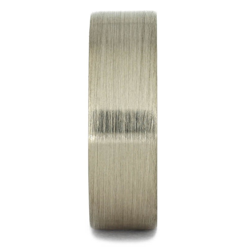 May include: A brushed silver ring with a wide band.