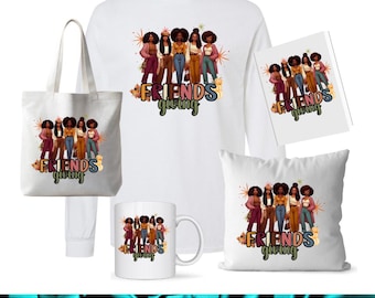 May include: A selection of white items, including a tote bag, long-sleeved top, mug, cushion, and card, all displaying a graphic of six women. The graphic and items feature the text "Friendsgiving".