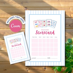 May include: Two printable Mahjong scorecards with light blue striped borders and a pink grid for tracking scores. The cards feature illustrations of five Mahjong tiles at the top and the text Mahjong Scorecard in pink script. Includes a pink Canva logo.