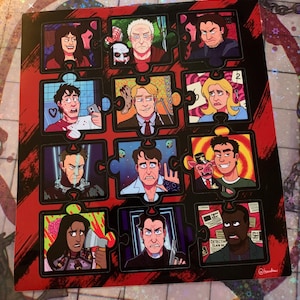 May include: A red and black puzzle-style sticker sheet featuring 12 different characters from the horror movie "Scream". The characters are depicted in a cartoon style with various expressions and poses. The sticker sheet is designed to look like a jigsaw puzzle with each character in a separate piece.