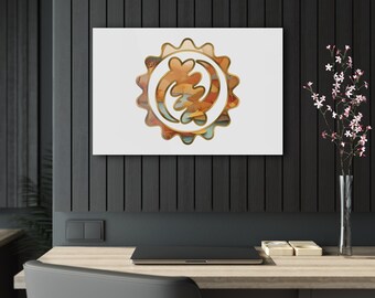 May include: A white canvas print with a gold-colored Adinkra symbol, the Sankofa, on a black wood background. The symbol is a stylized bird with its head turned backward, representing the importance of learning from the past.
