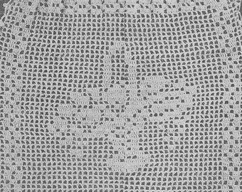 May include: A white crocheted drawstring bag with a delicate floral pattern. The bag has a scalloped edge and is made with a fine thread.