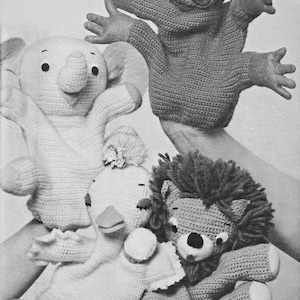 May include: Four crocheted hand puppets: a frog, an elephant, a duck, and a lion. The puppets are all white except for the frog, which is brown.