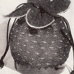 May include: A black crocheted drawstring bag with a white trim and a decorative top. The bag has a long black cord with a tassel at the end.