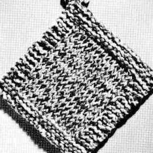 May include: A knitted pot holder with a loop handle. The pot holder is made with a textured stitch pattern and is a neutral gray color.