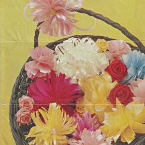 May include: A wicker basket filled with colorful silk flowers. The flowers are arranged in a variety of shapes and sizes, including roses, carnations, and daisies. The basket is decorated with a ribbon.