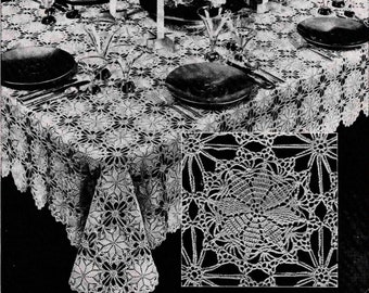 May include: A white crocheted tablecloth with a delicate floral pattern. The tablecloth is set for a formal dinner with plates, glasses, and candlesticks.
