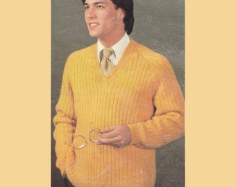 May include: A yellow knitted v-neck sweater with a ribbed texture. The sweater has long sleeves and a relaxed fit.