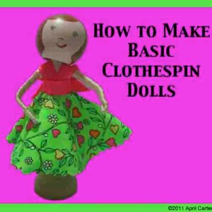 May include: How to Make Basic Clothespin Dolls. A green, red and white clothespin doll with a floral skirt and red top. The doll is standing on a wooden base.