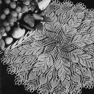 May include: A white crocheted doily with a delicate floral design. The doily is circular and has a scalloped edge.