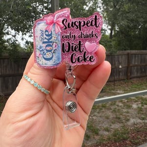 Le suspect ne boit que du coca light. Aimant ou enrouleur de badge rétractable mignon, amusant et scintillant. Cadeau pour collègue, carte d'enseignant, carte d'étudiant, inf.