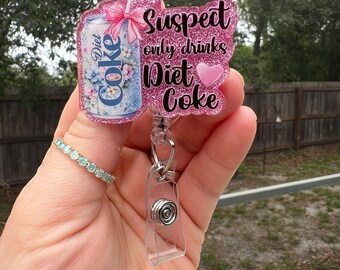 Il sospettato beve solo Coca-Cola Light. Simpatico, divertente, porta badge retrattile glitterato o calamita. Regalo per colleghi, tesserino insegnante, tesserino studente, infermiere professionale, turno pomeridiano.