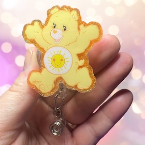care bear lovers here they are and oh so adorable. Glitter retractable badge reel. Fun gift-teacher-student ID-nurse-RN-co worker.