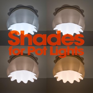 May include: Four scalloped light shades for pot lights displayed in a grid, each emitting a different colour temperature of light ranging from cool white to warm yellow. The text "Shades for Pot Lights" is overlaid in large orange letters.