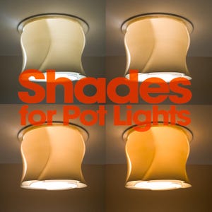 Puede incluir: Cuatro pantallas para luces empotradas con una silueta curva en forma de campana instaladas en un techo. Cada pantalla emite una temperatura de color diferente, desde blanco frío hasta ámbar cálido. El texto "Shades for Pot Lights" está superpuesto.