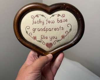 Marco de madera con forma de corazón bordado a punto de cruz estilo vintage. Placa de pared con la inscripción "Los abuelos tienen suerte" de los años 80.