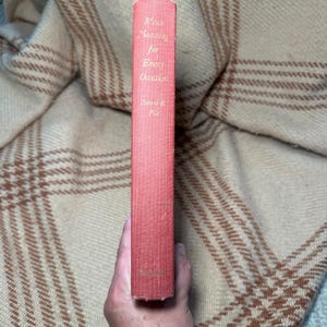 May include: A red hardcover book spine with gold lettering that reads Menu Planning for Every Occasion by Robert S. Pile, with the publisher name Doubleday printed at the bottom. The book has a textured fabric cover and a rectangular shape.